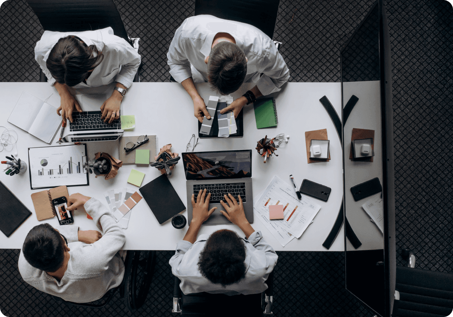 A team reviewing colour swatches and charts at a desk